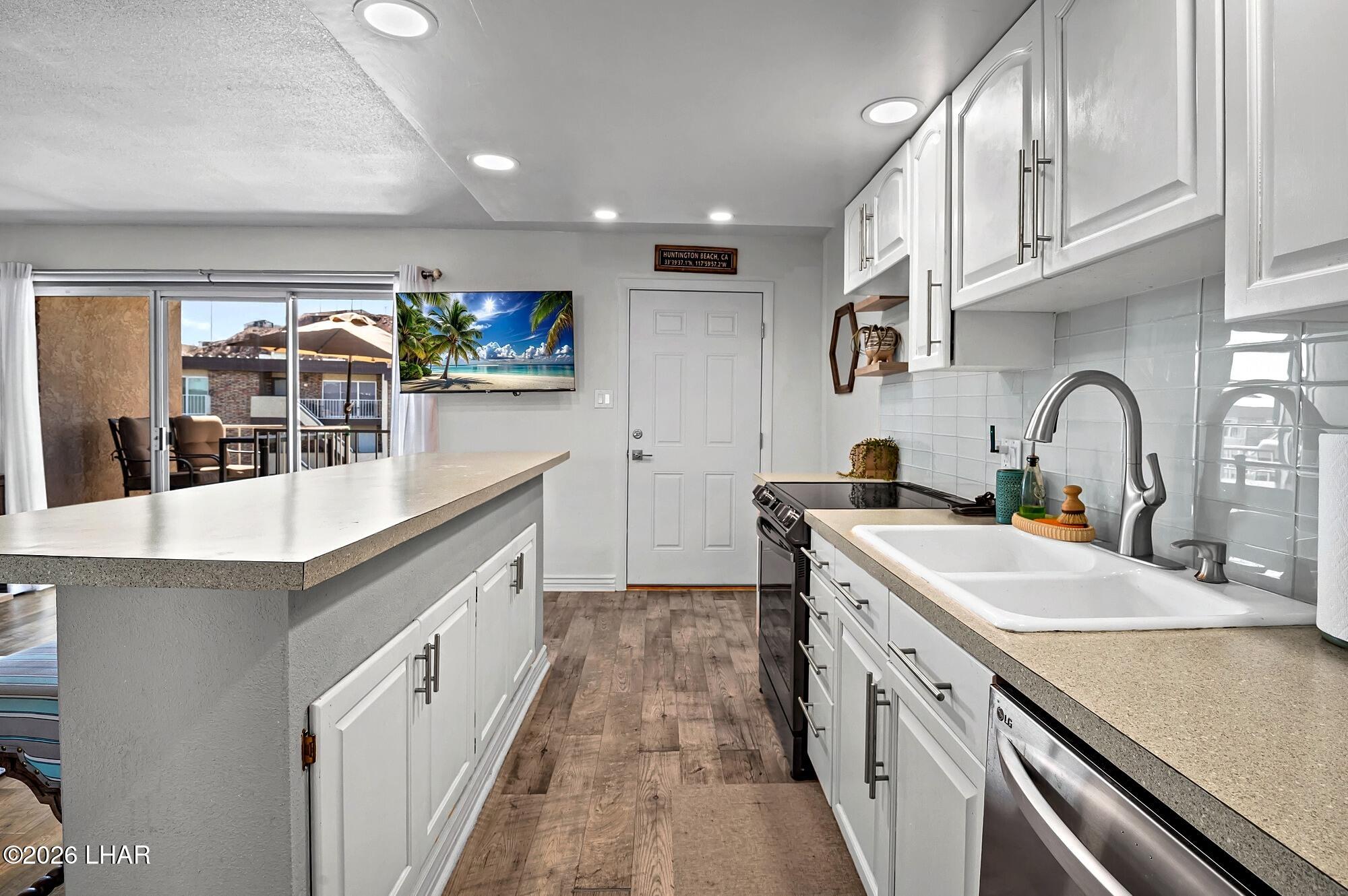 9170 Riverside Drive, Unit 13 Parker, AZ 85344 - Photo 16 of 51 a kitchen with stainless steel appliances a sink and a stove
