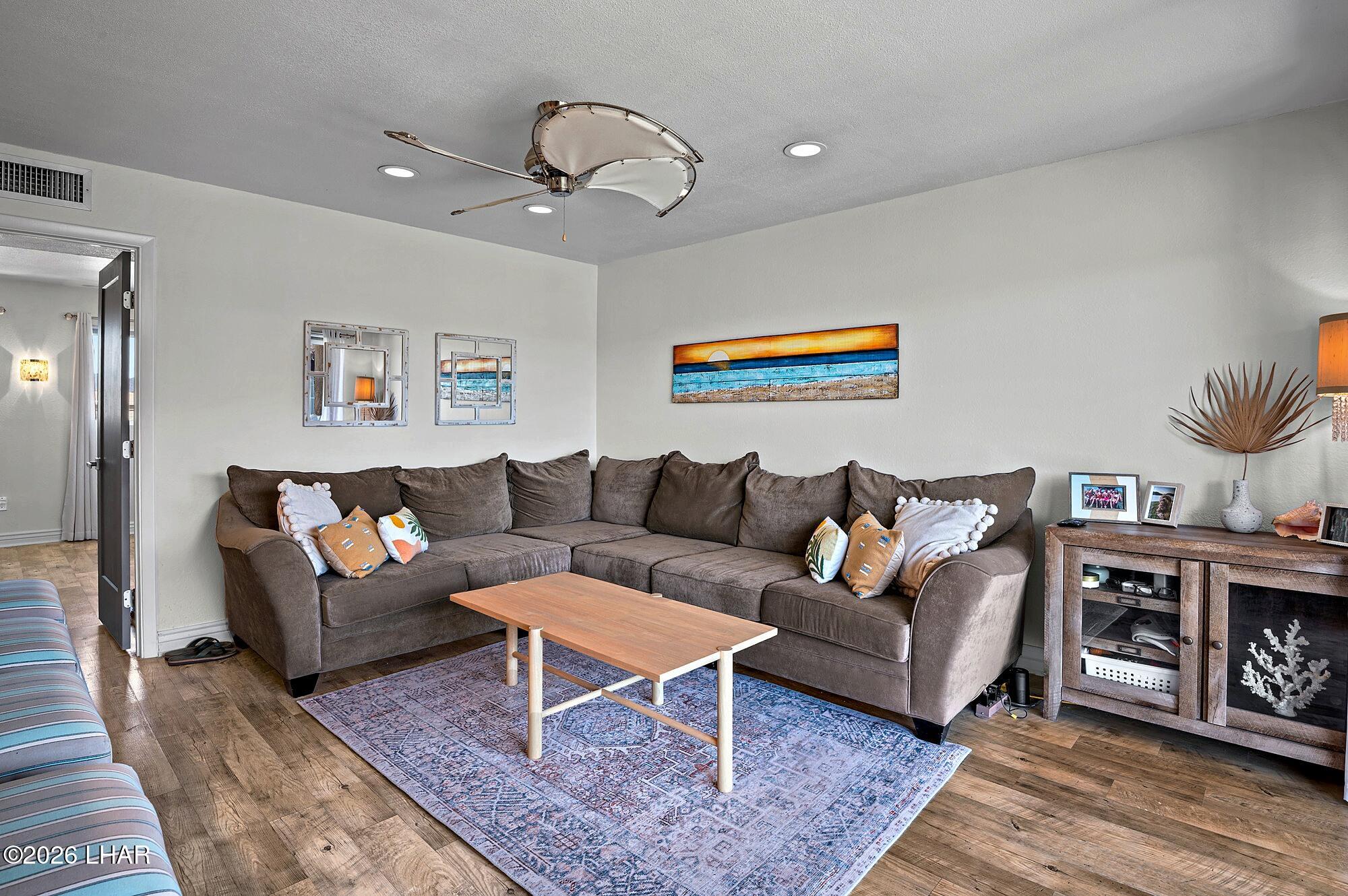 9170 Riverside Drive, Unit 13 Parker, AZ 85344 - Photo 20 of 51 a living room with furniture and a bookshelf