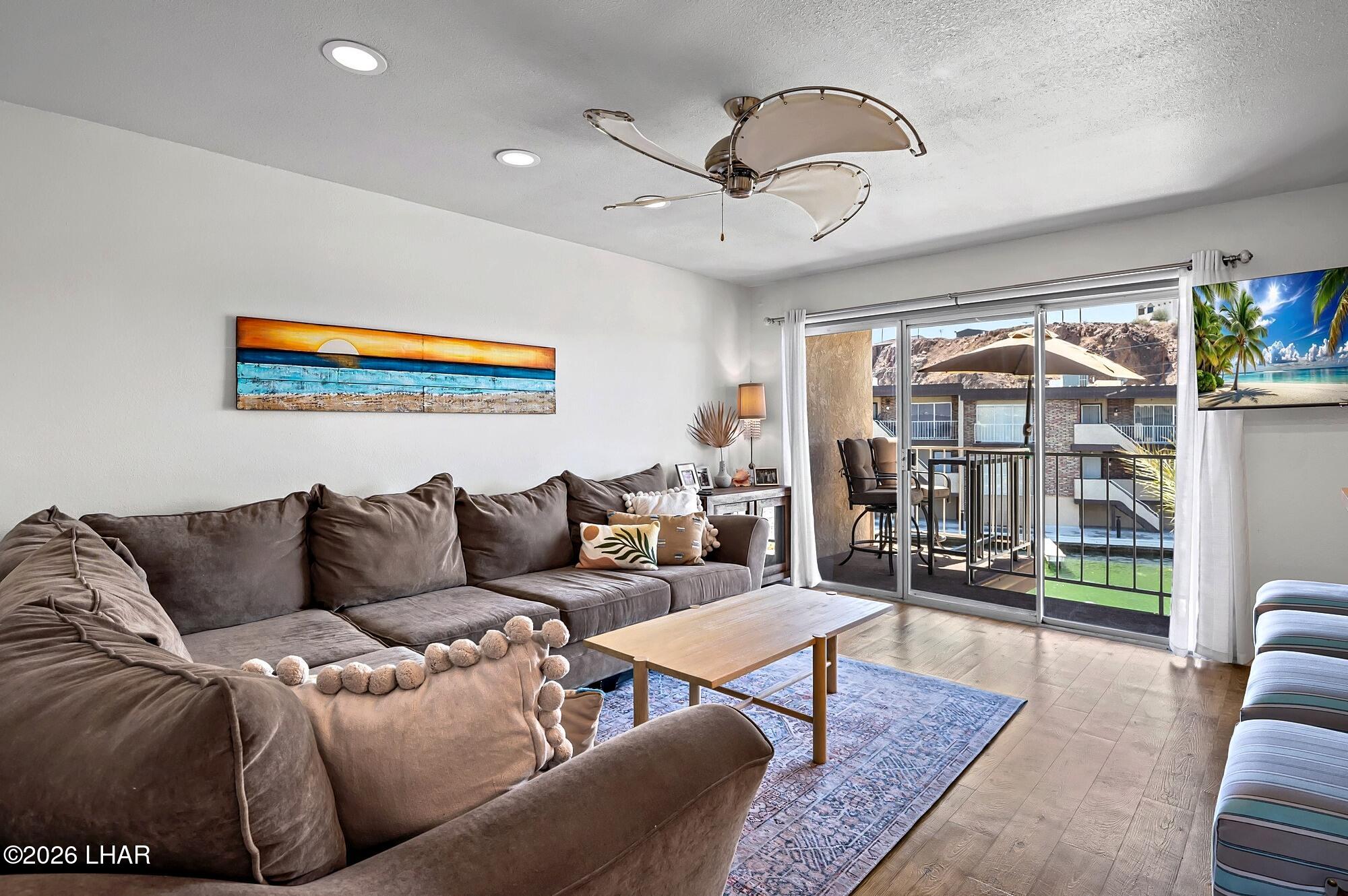 9170 Riverside Drive, Unit 13 Parker, AZ 85344 - Photo 21 of 51 a living room with furniture and a large window