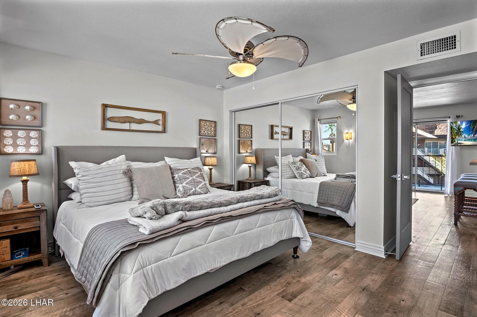 9170 Riverside Drive, Unit 13 Parker, AZ 85344 - Photo 22 of 51 a bedroom with bed and a chandelier
