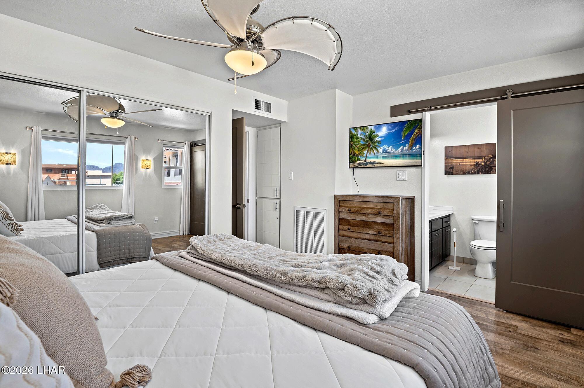 9170 Riverside Drive, Unit 13 Parker, AZ 85344 - Photo 24 of 51 a bedroom with a bed and a television