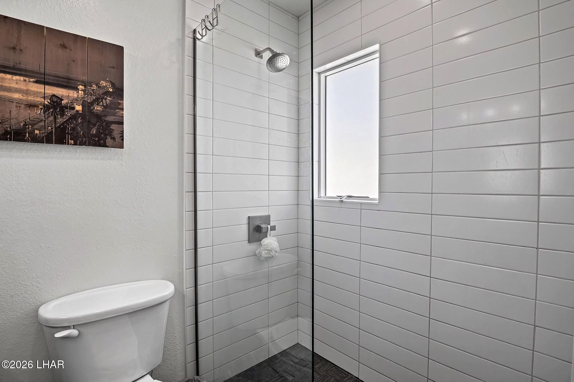 9170 Riverside Drive, Unit 13 Parker, AZ 85344 - Photo 27 of 51 a bathroom with a toilet and shower