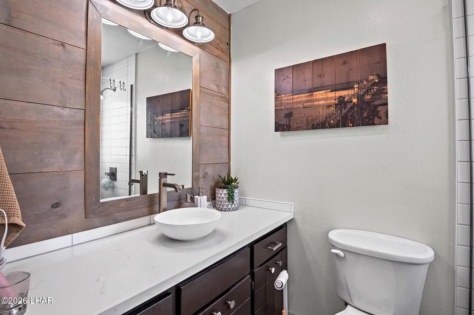 9170 Riverside Drive, Unit 13 Parker, AZ 85344 - Photo 29 of 51 a bathroom with a toilet a sink and mirror