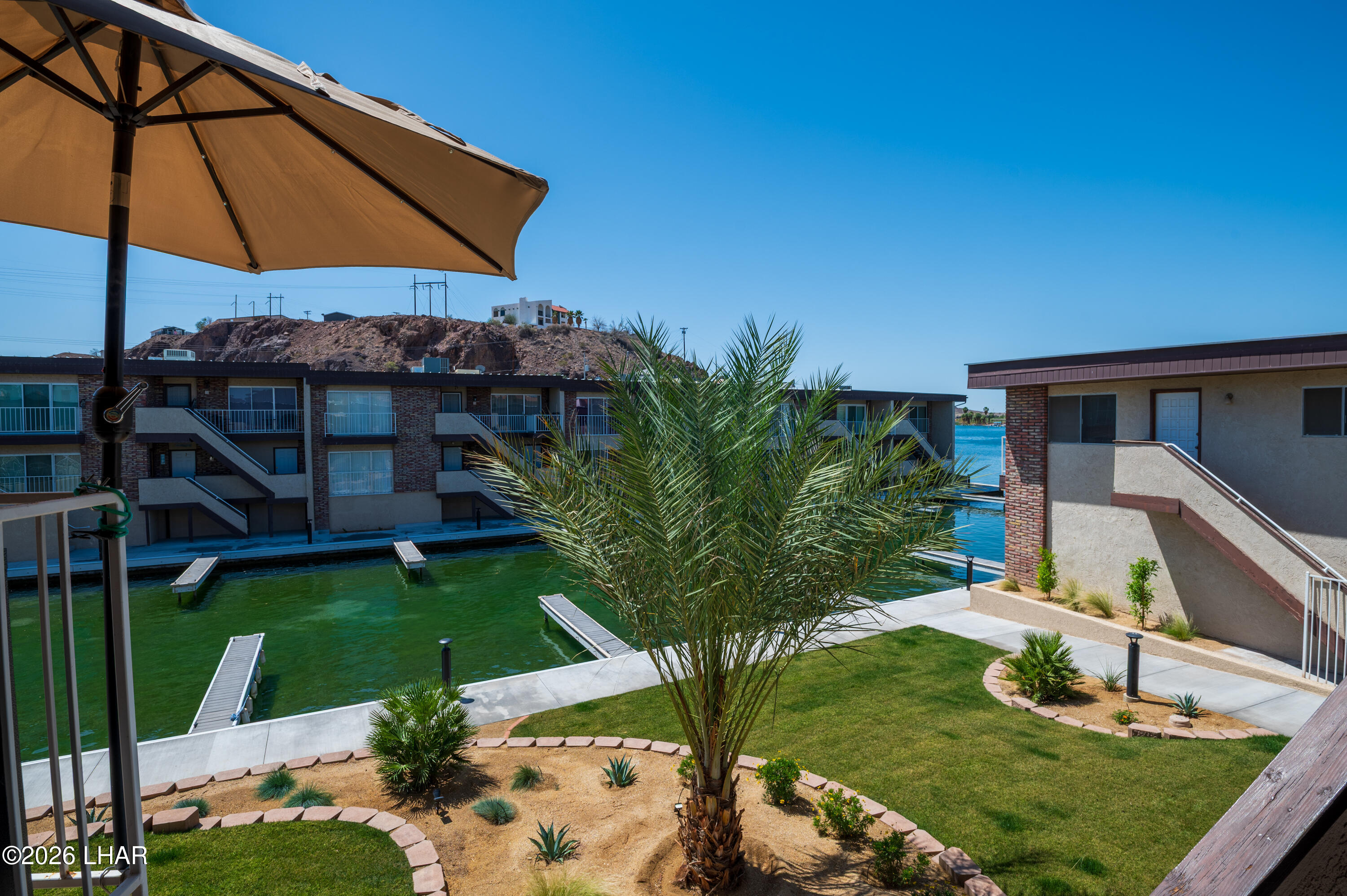 9170 Riverside Drive, Unit 13 Parker, AZ 85344 - Photo 3 of 51 a view of a house with garden space and sitting area