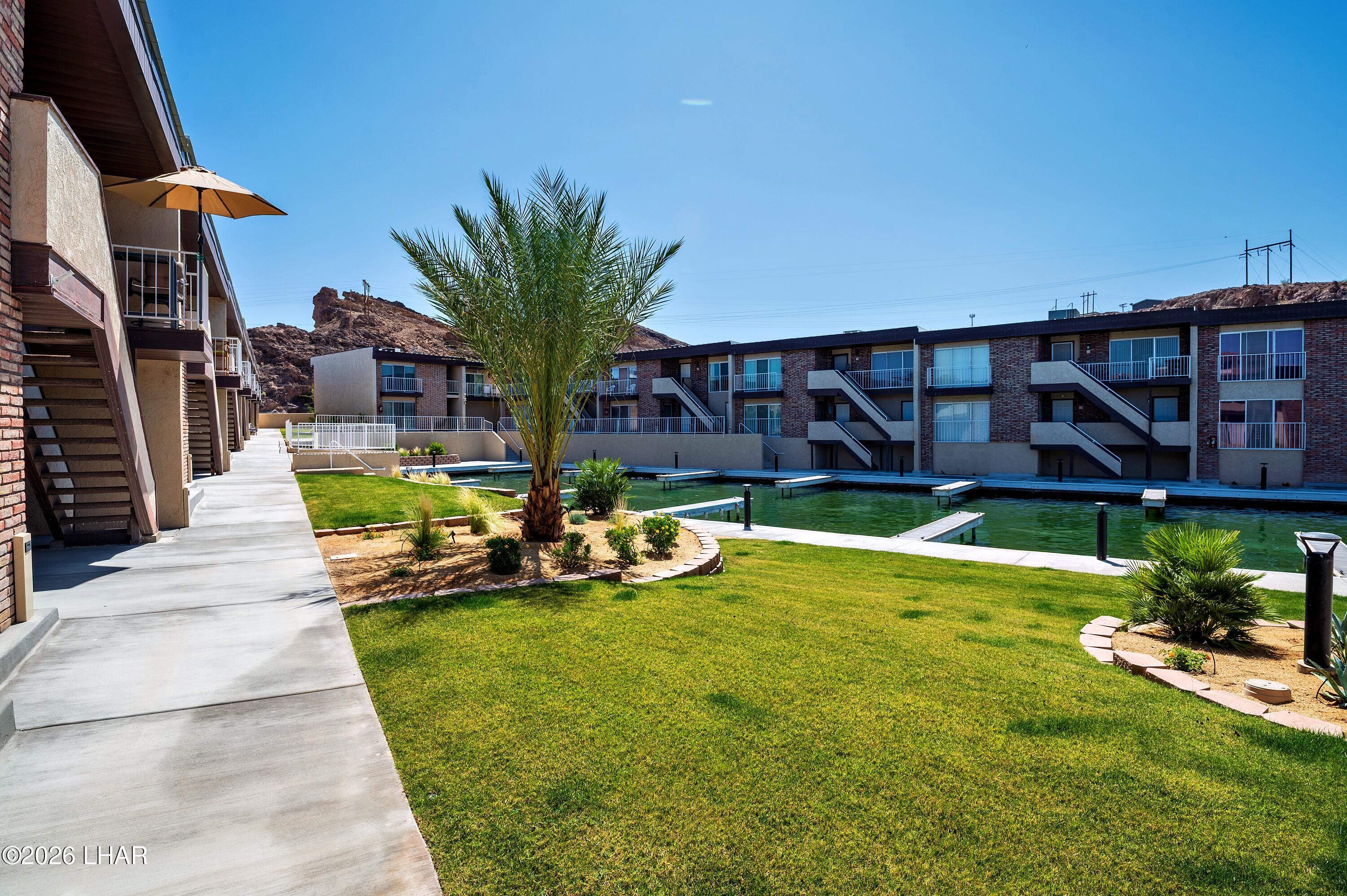 9170 Riverside Drive, Unit 13 Parker, AZ 85344 - Photo 50 of 51 a view of a house with swimming pool and sitting area