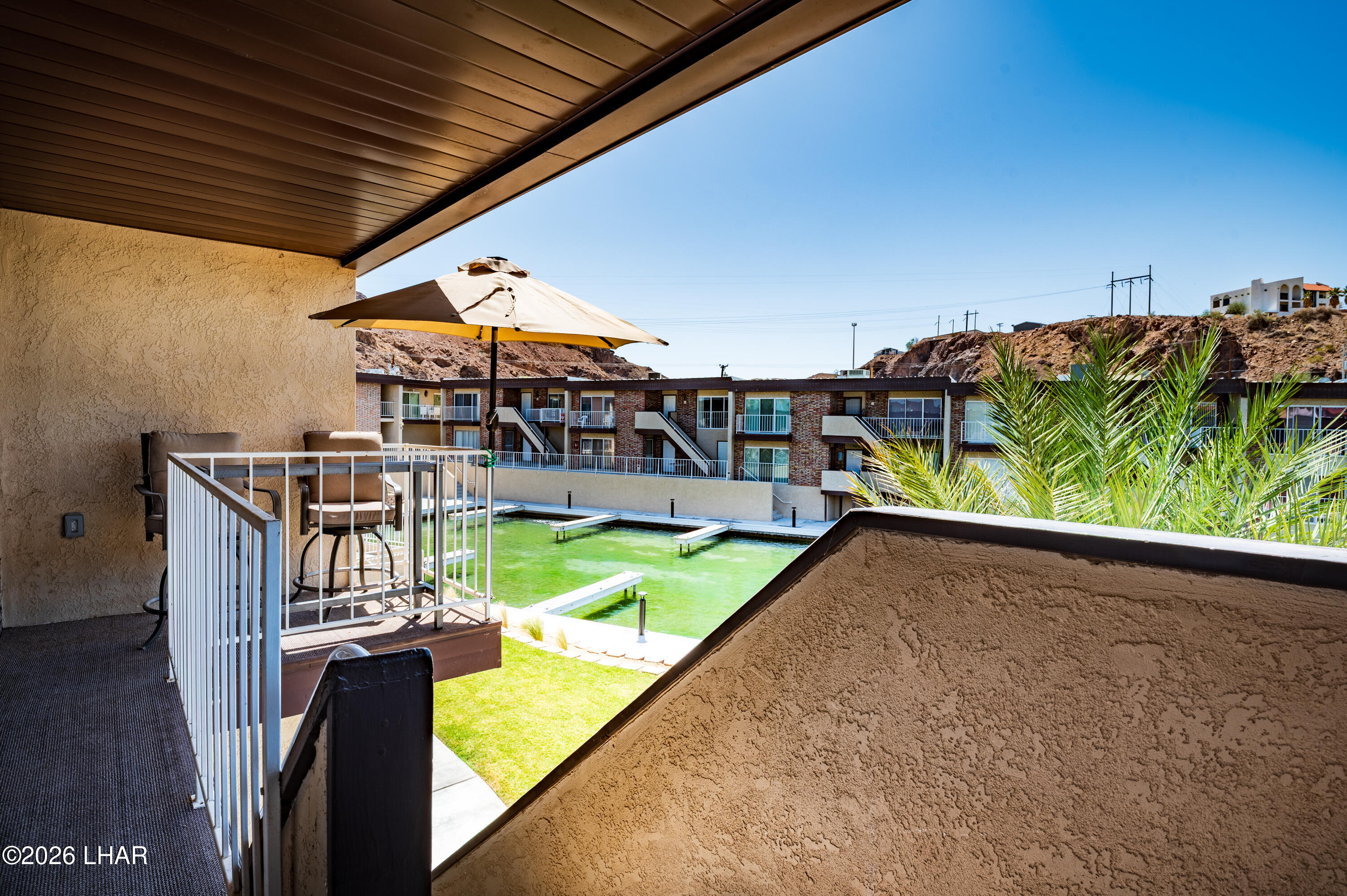 9170 Riverside Drive, Unit 13 Parker, AZ 85344 - Photo 6 of 51 a view of a balcony with chairs
