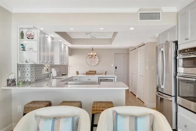 a kitchen with stainless steel appliances kitchen island granite countertop a sink and cabinets