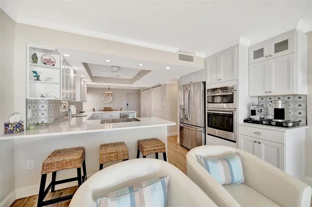 a large kitchen with stainless steel appliances kitchen island granite countertop a large counter top space and cabinets