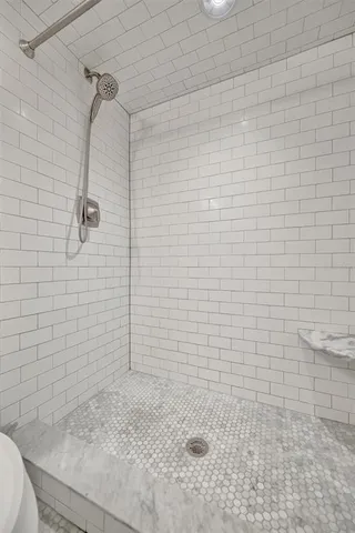 a bedroom with a bed and a flat tv screen on the dresser