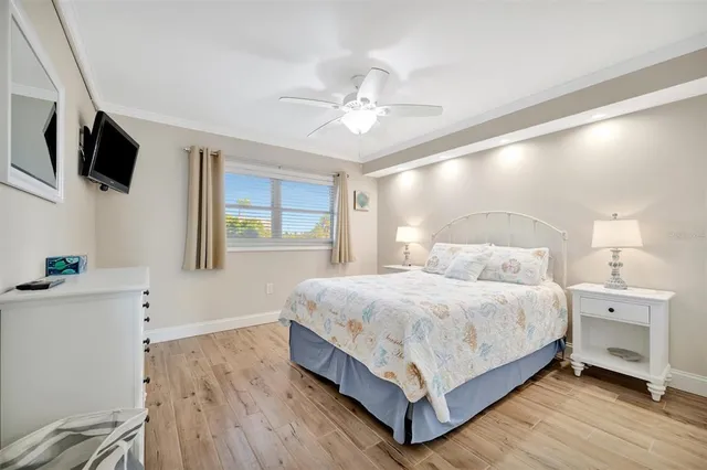 a bedroom with a bed a window and a chandelier