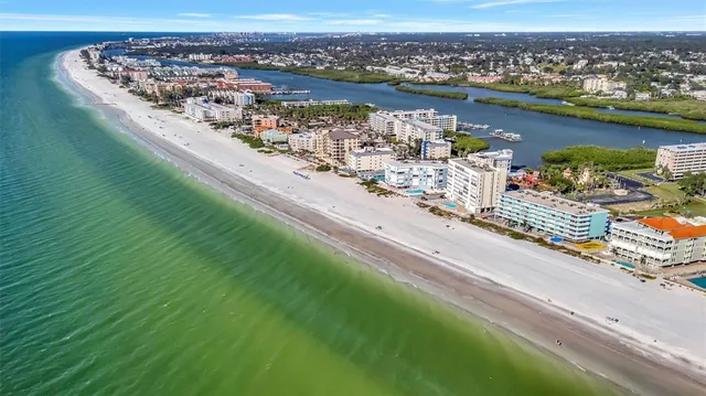 an aerial view of a house with a yard and lake view