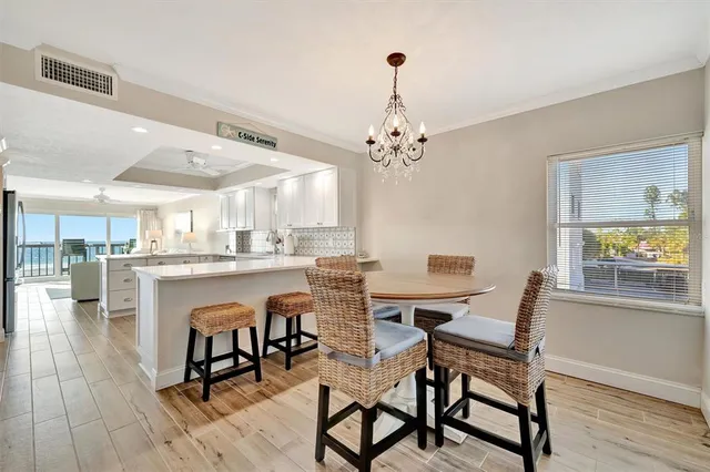 a kitchen with granite countertop a sink a stove and cabinets