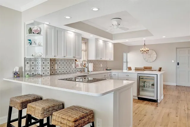 a view of a dining room with furniture and a chandelier