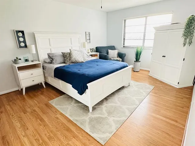 a spacious bedroom with a bed and window