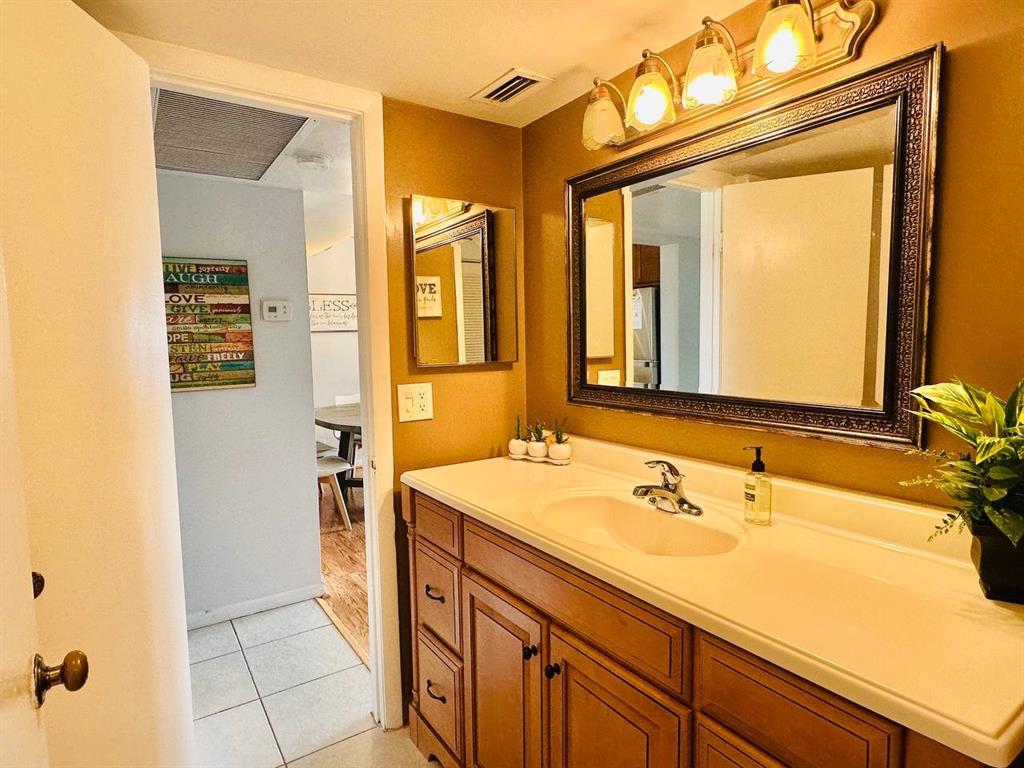 9300 Southwest 8th Street, Unit 214 Boca Raton, FL 33428 - Photo 20 of 32 a bathroom with a sink and a mirror