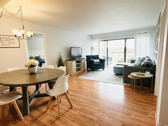a view of a dining room with furniture window and wooden floor