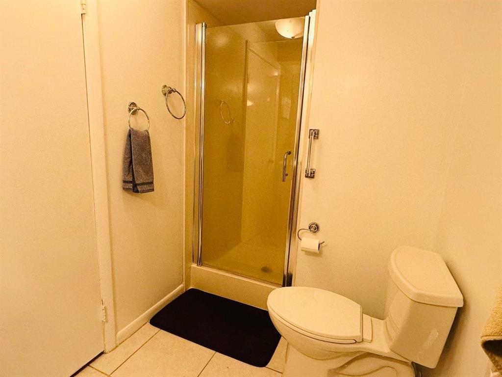 9300 Southwest 8th Street, Unit 214 Boca Raton, FL 33428 - Photo 22 of 32 a bathroom with a toilet and a shower