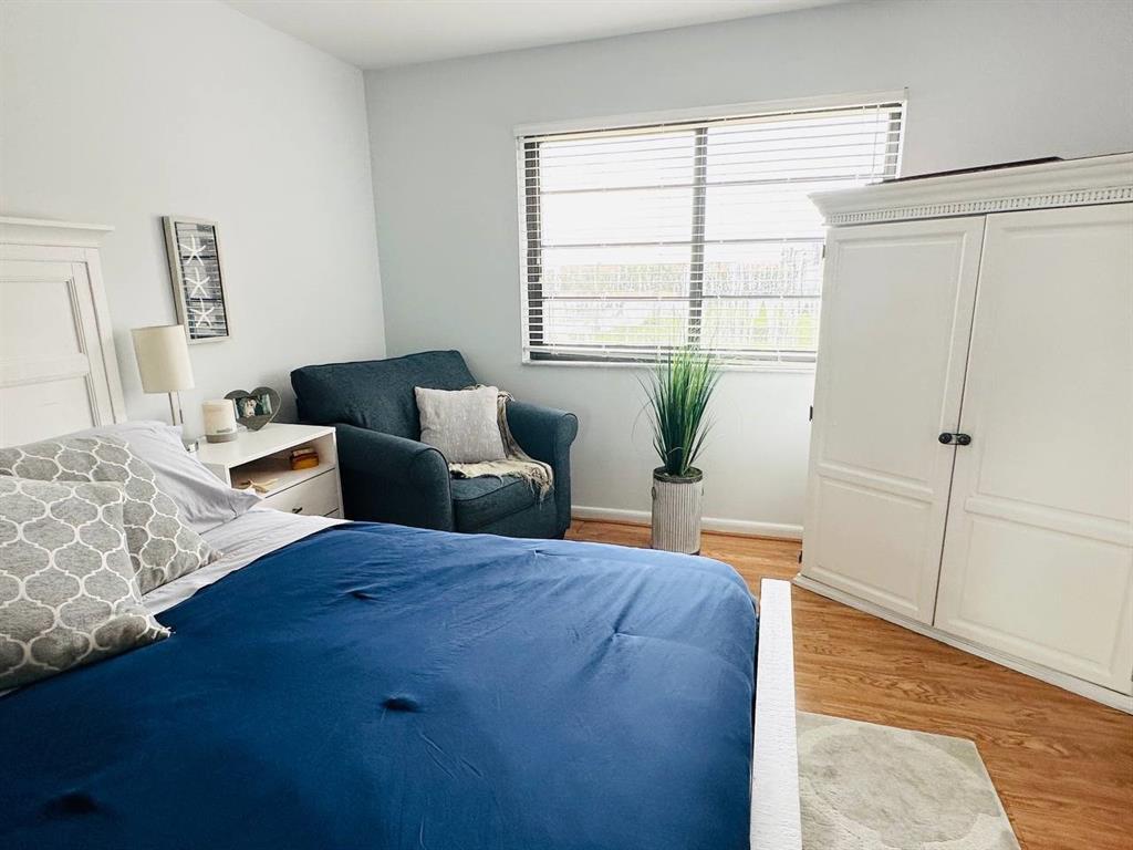 9300 Southwest 8th Street, Unit 214 Boca Raton, FL 33428 - Photo 24 of 32 a bedroom with bed and window