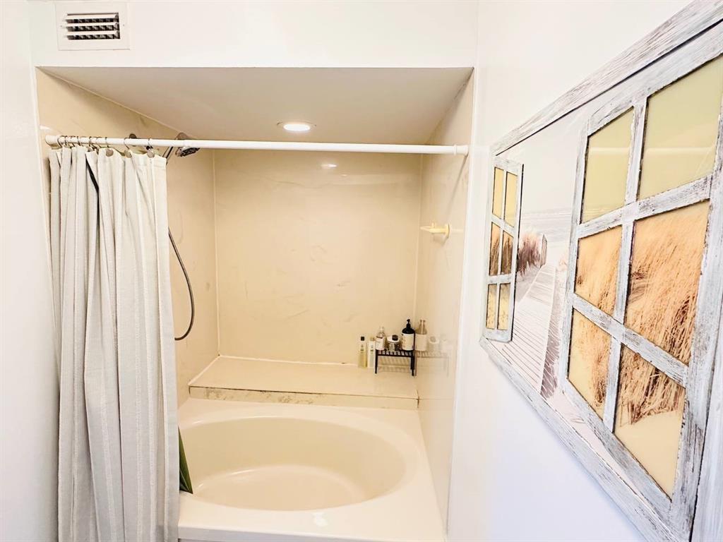 9300 Southwest 8th Street, Unit 214 Boca Raton, FL 33428 - Photo 27 of 32 a bathroom with a bathtub and a shower