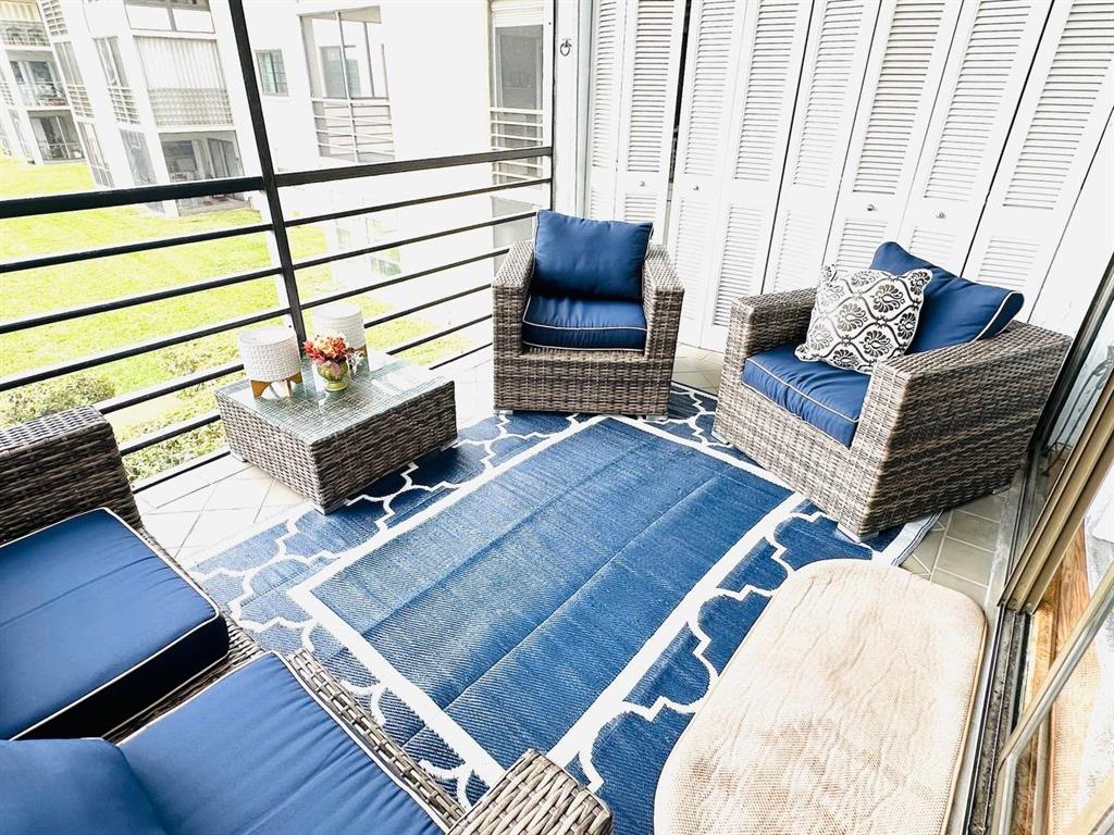 9300 Southwest 8th Street, Unit 214 Boca Raton, FL 33428 - Photo 30 of 32 a living room with furniture and a fireplace