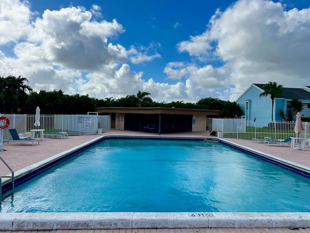 9300 Southwest 8th Street, Unit 214 Boca Raton, FL 33428 - Photo 31 of 32 a view of a terrace with a lounge chair