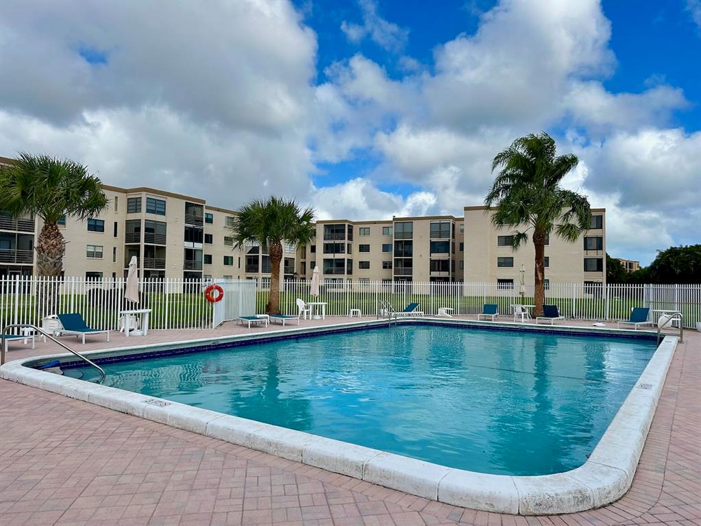 9300 Southwest 8th Street, Unit 214 Boca Raton, FL 33428 - Photo 32 of 32 a view of swimming pool is middle in the backyard