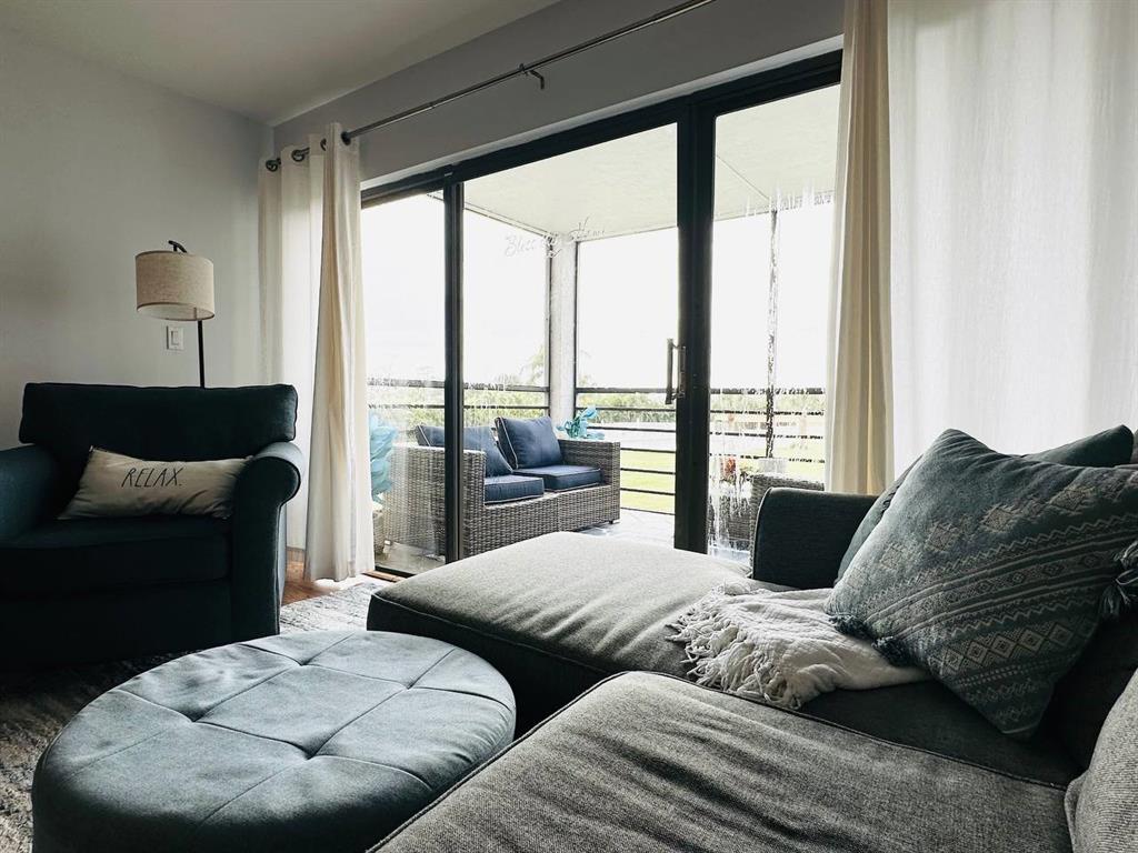 9300 Southwest 8th Street, Unit 214 Boca Raton, FL 33428 - Photo 5 of 32 a living room with furniture and large windows