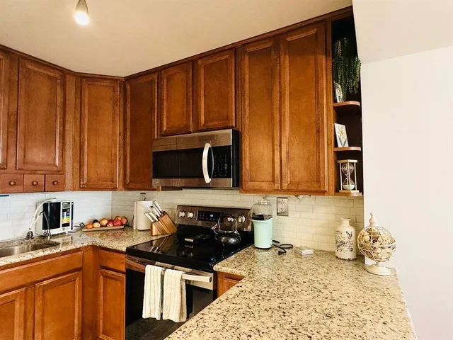 a kitchen with a sink stove and cabinets