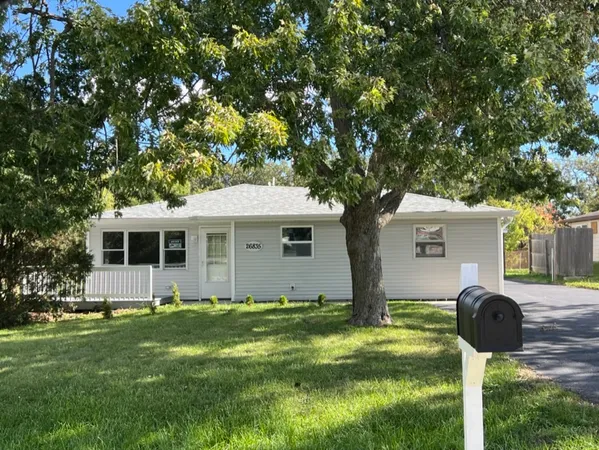 a front view of house with yard and green space