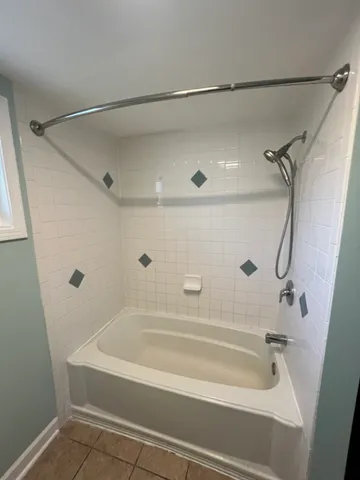 a bathroom with a tub and shower