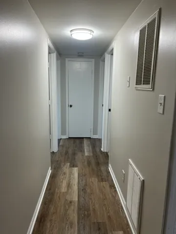 a view of hallway with wooden floor