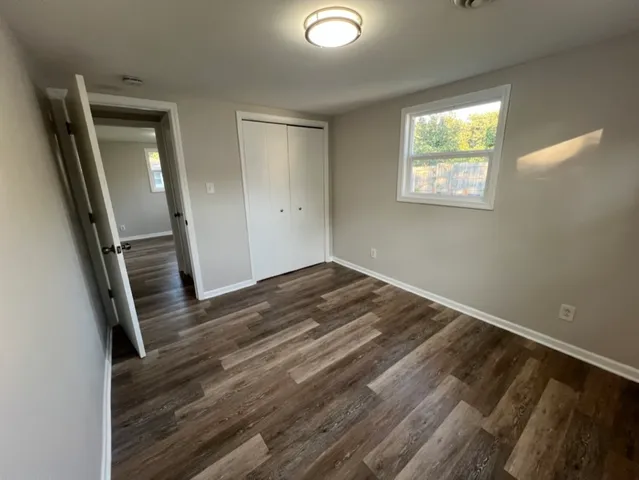 wooden floor in an empty room with a mirror