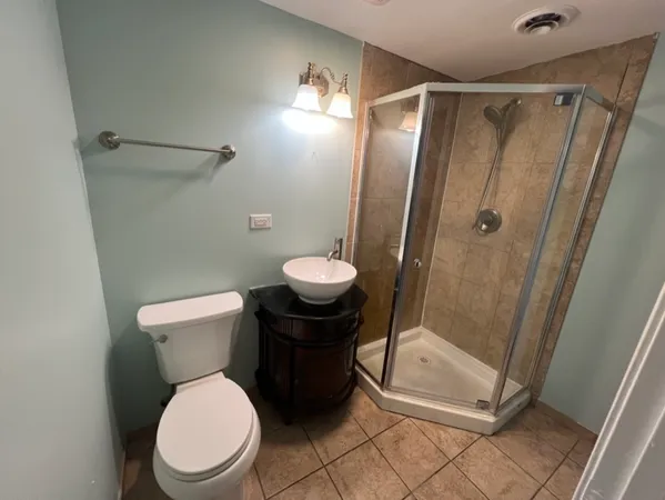 a bathroom with a toilet and a shower