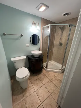 a bathroom with a toilet and a shower