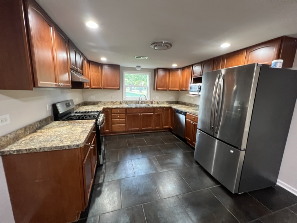 26835 South Linden Lane Crete, IL 60417 - Photo 3 of 31 a kitchen with stainless steel appliances granite countertop a refrigerator a stove a sink and a microwave