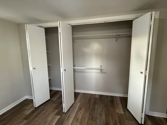 a view of walk in closet with wooden floor