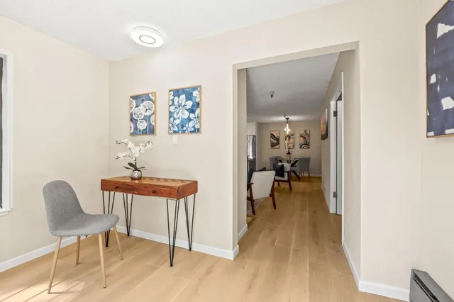 a view of a room with furniture and wooden floor