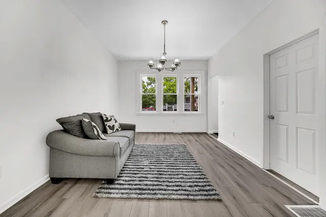 a living room with furniture and a chandelier