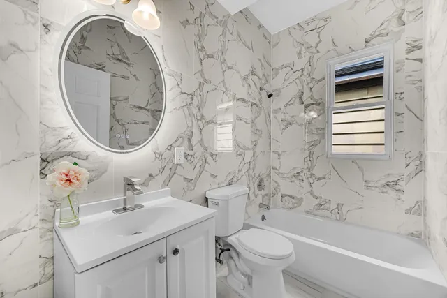 a bathroom with a sink a toilet and a mirror