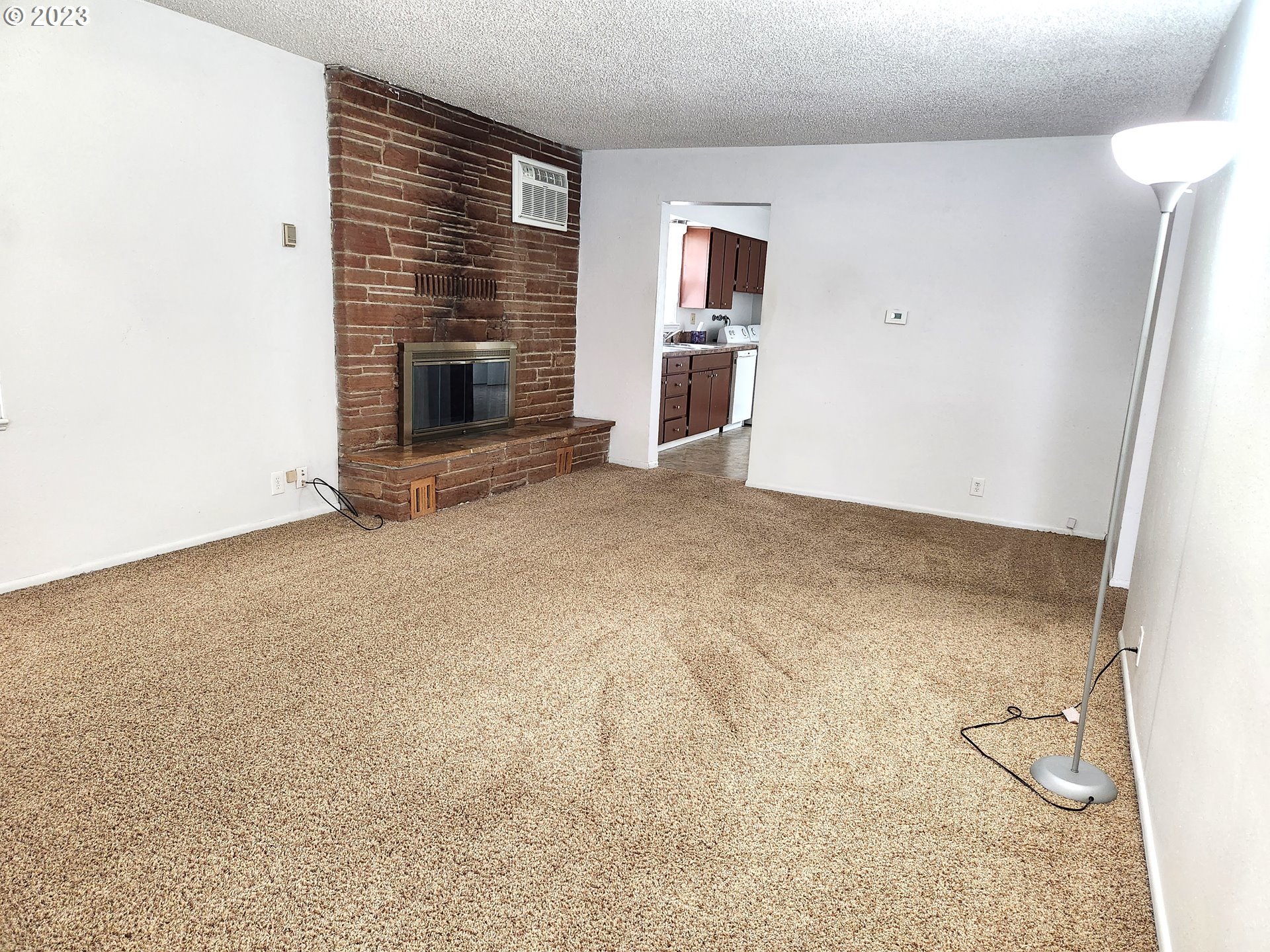 809 15th Street La Grande, OR 97850 - Photo 2 of 11 an empty room with windows and fireplace
