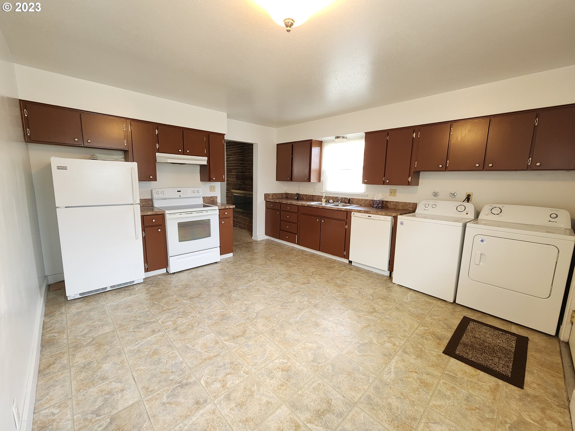 809 15th Street La Grande, OR 97850 - Photo 3 of 11 a kitchen with refrigerator cabinets and stove top oven
