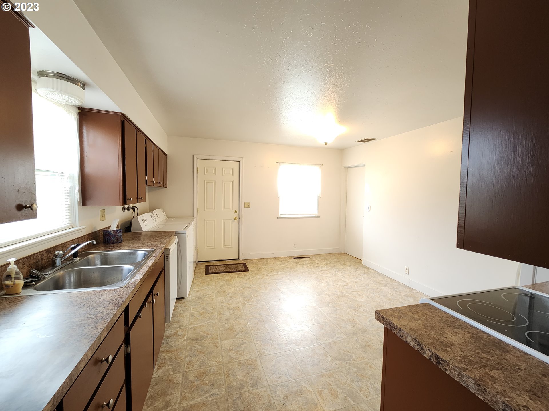 809 15th Street La Grande, OR 97850 - Photo 4 of 11 a kitchen with granite countertop a sink a stove and cabinets