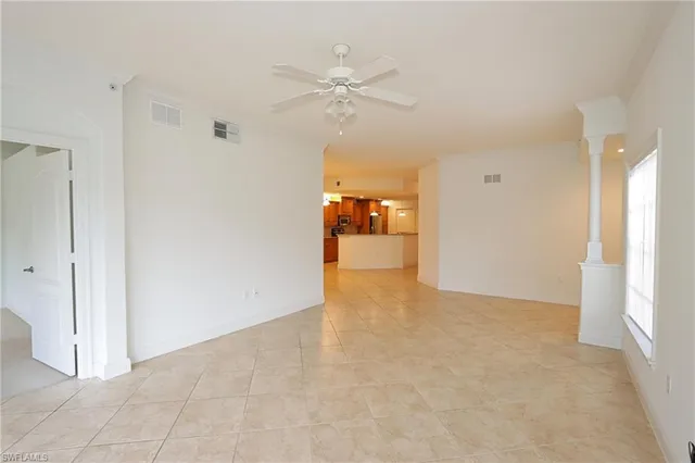 a view of a livingroom with a ceiling fan and entryway