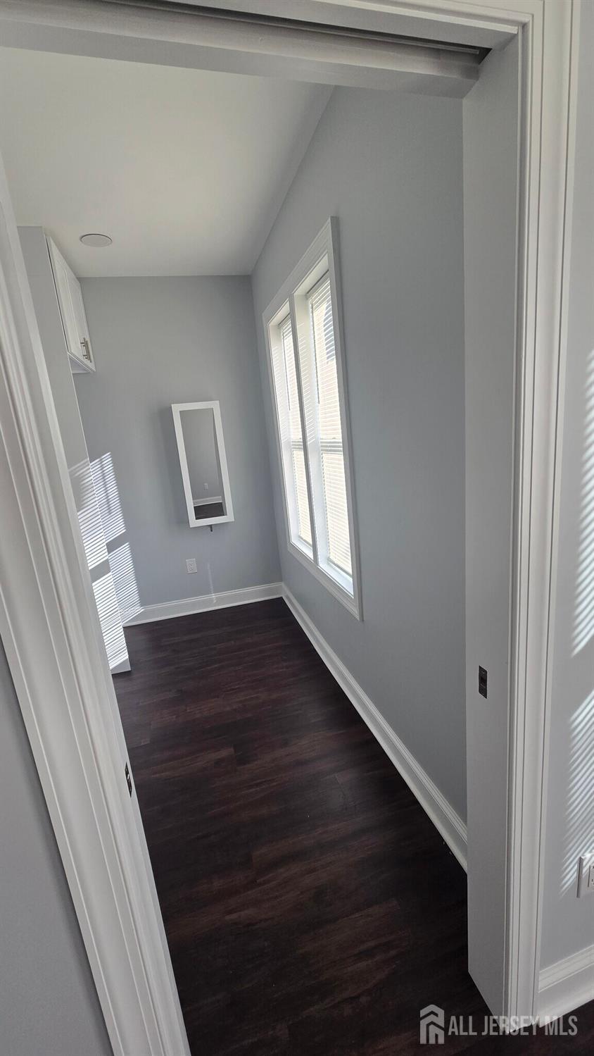 272 Market Street Perth Amboy, NJ 08861 - Photo 11 of 20 a view of an empty room with wooden floor and a window