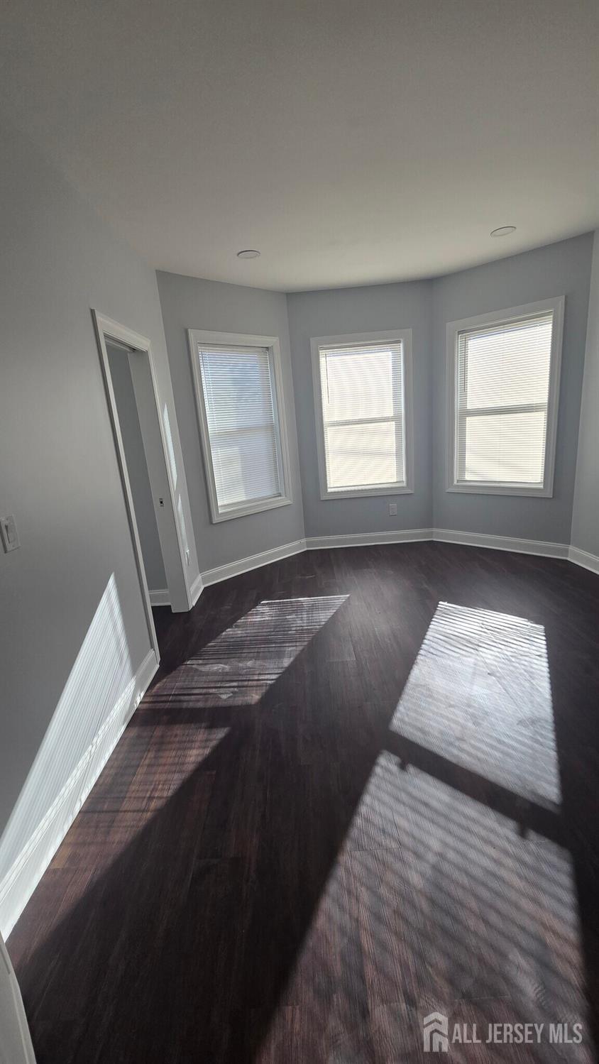 272 Market Street Perth Amboy, NJ 08861 - Photo 12 of 20 a view of a bedroom with wooden floor and window