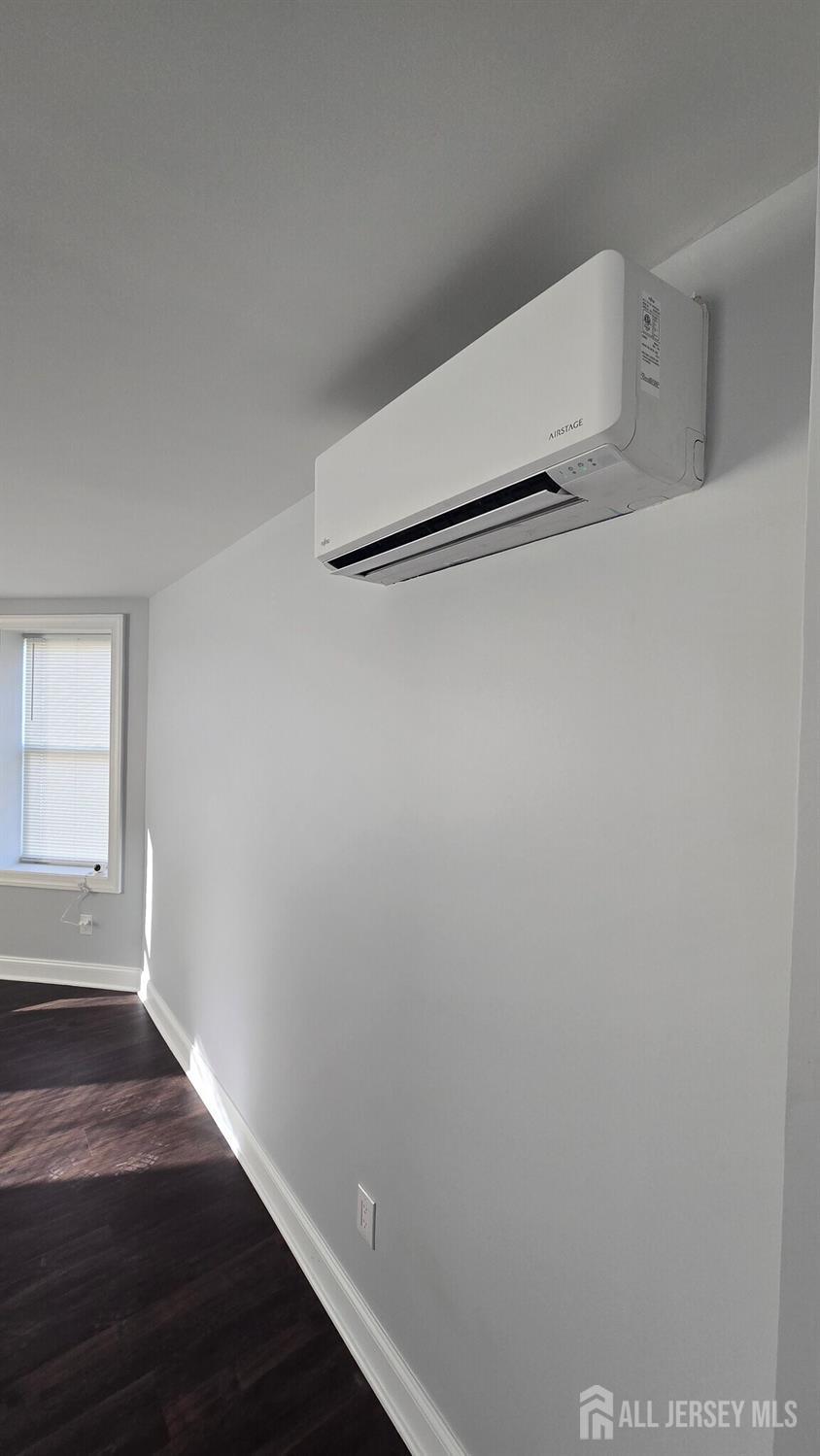 272 Market Street Perth Amboy, NJ 08861 - Photo 13 of 20 an empty room with wooden floor and windows