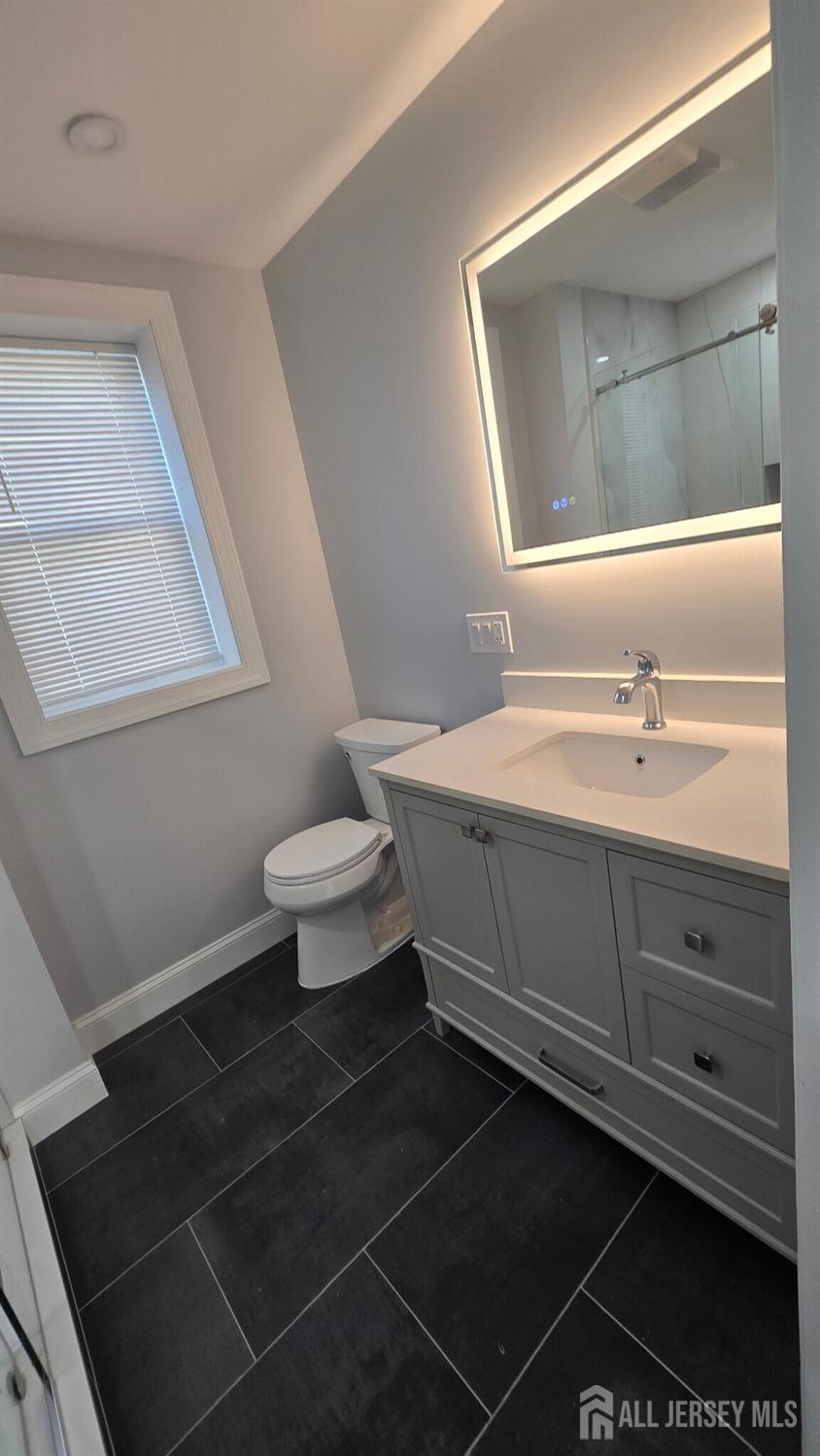 272 Market Street Perth Amboy, NJ 08861 - Photo 16 of 20 a bathroom with a sink toilet and mirror