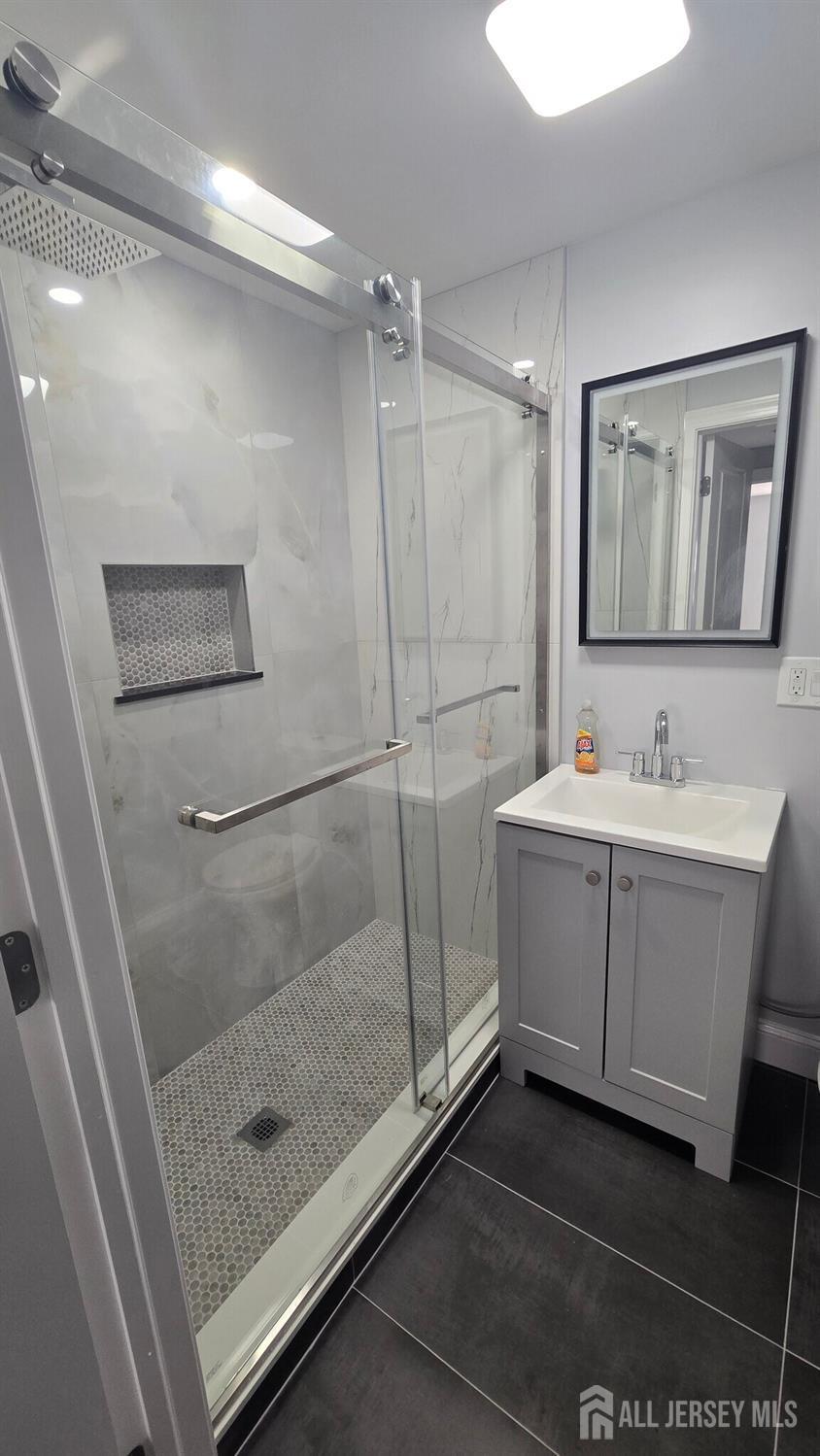 272 Market Street Perth Amboy, NJ 08861 - Photo 5 of 20 a bathroom with a sink mirror and a shower
