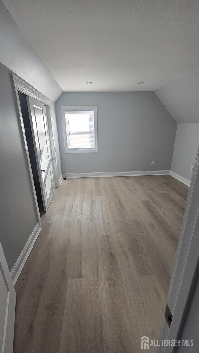 272 Market Street Perth Amboy, NJ 08861 - Photo 7 of 20 wooden floor in an empty room with a window