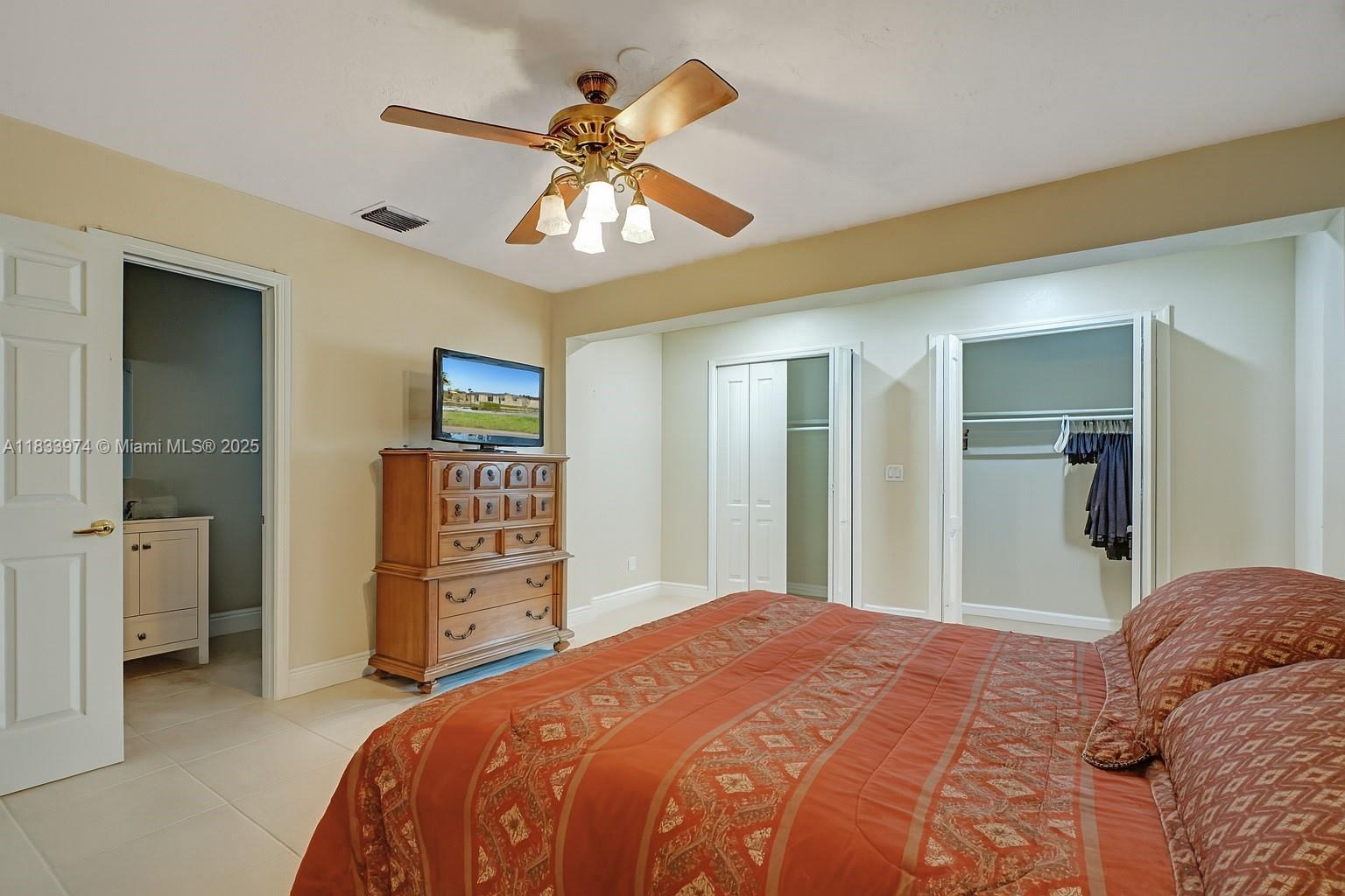 12763 Southwest 45th Terrace Miami, FL 33175 - Photo 12 of 30 a bedroom with a bed and a chandelier